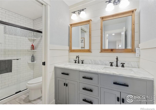 6434 Cloudburst Ave, Timnath, CO 80547 - bathroom with double vanity, a stall shower, and toilet