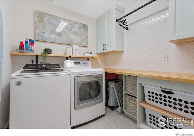 6434 Cloudburst Ave, Timnath, CO 80547 - laundry room featuring separate washer and dryer, light tile patterned flooring, and cabinet space