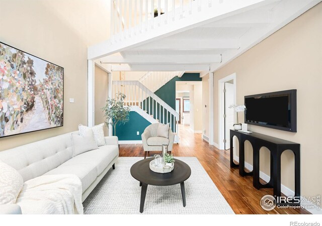 93 Benthaven Pl, Boulder, CO 80305 - living room with stairway, beam ceiling, wood finished floors, and baseboards