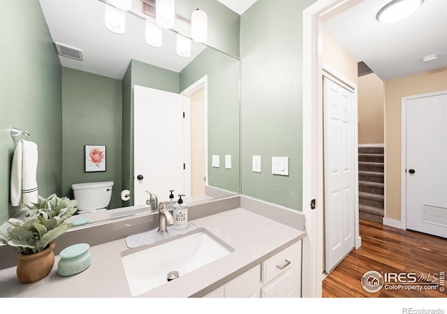 93 Benthaven Pl, Boulder, CO 80305 - bathroom with wood finished floors, vanity, and toilet
