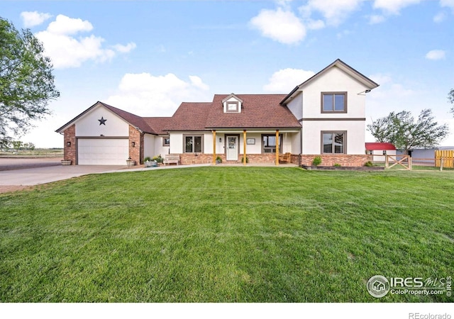 33820 County Road 47, Greeley, CO 80631 - view of front of property featuring stucco siding, driveway, a garage, covered porch, and brick siding