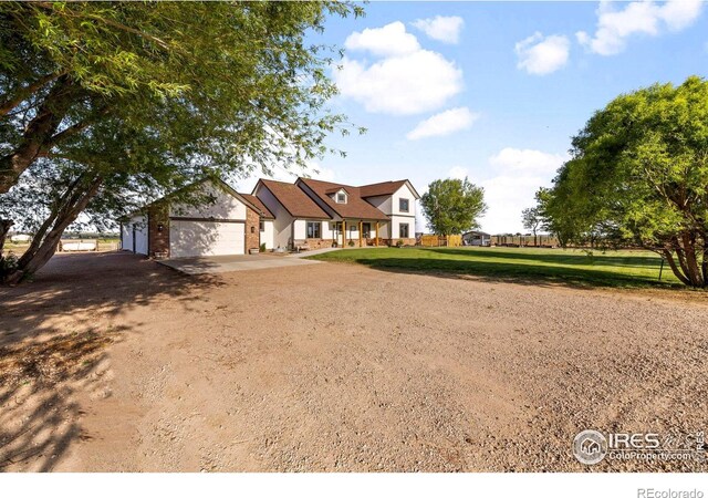 33820 County Road 47, Greeley, CO 80631 - view of front of house featuring a garage, brick siding, and dirt driveway