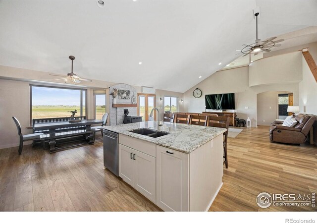 33820 County Road 47, Greeley, CO 80631 - kitchen featuring a ceiling fan, open floor plan, stainless steel dishwasher, a sink, and an island with sink