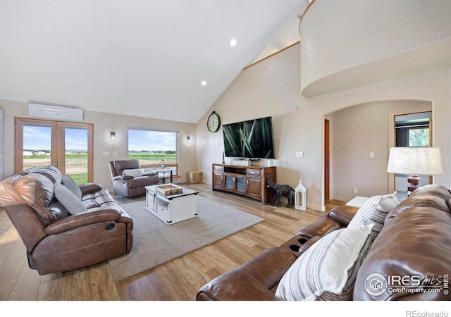 33820 County Road 47, Greeley, CO 80631 - living room featuring an AC wall unit, high vaulted ceiling, wood finished floors, french doors, and recessed lighting