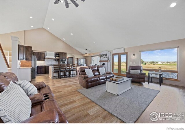 33820 County Road 47, Greeley, CO 80631 - living room with high vaulted ceiling, a ceiling fan, light wood-type flooring, and recessed lighting