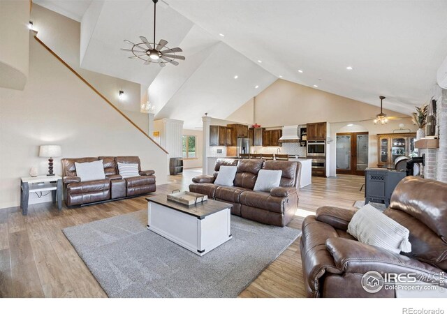 33820 County Road 47, Greeley, CO 80631 - living room with ceiling fan, high vaulted ceiling, light wood finished floors, recessed lighting, and arched walkways