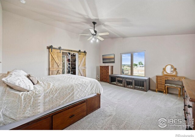 33820 County Road 47, Greeley, CO 80631 - carpeted bedroom with a barn door, lofted ceiling, and ceiling fan