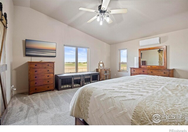 33820 County Road 47, Greeley, CO 80631 - carpeted bedroom featuring lofted ceiling, a wall unit AC, a barn door, and ceiling fan