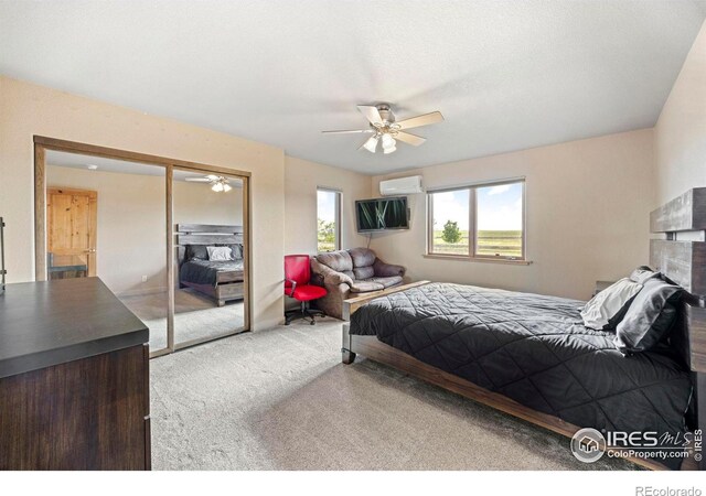 33820 County Road 47, Greeley, CO 80631 - carpeted bedroom featuring a wall unit AC, a closet, and a ceiling fan
