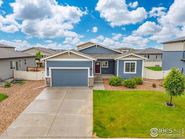 3925 Buckthorn St, Wellington, CO 80549 - view of front of home with concrete driveway, a garage, and stone siding