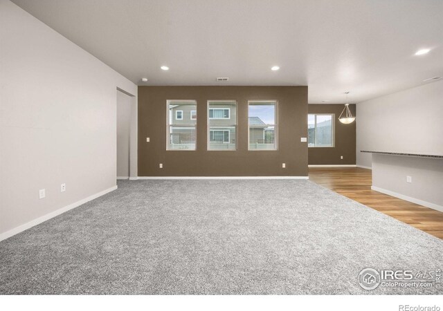 3925 Buckthorn St, Wellington, CO 80549 - empty room featuring carpet, recessed lighting, baseboards, and wood finished floors
