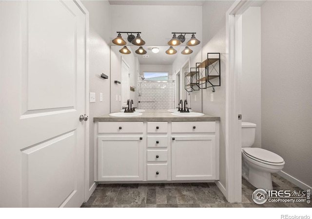 3925 Buckthorn St, Wellington, CO 80549 - bathroom with double vanity, toilet, and baseboards