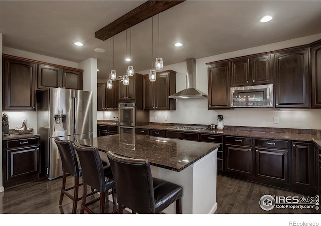 6356 Twilight Ave, Firestone, CO 80504 - kitchen with appliances with stainless steel finishes, wall chimney range hood, dark wood-type flooring, dark brown cabinetry, and recessed lighting