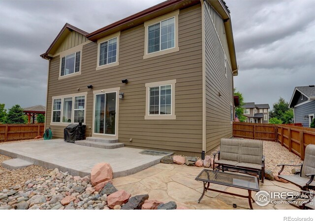6356 Twilight Ave, Firestone, CO 80504 - back of property featuring a patio area, a fenced backyard, and entry steps