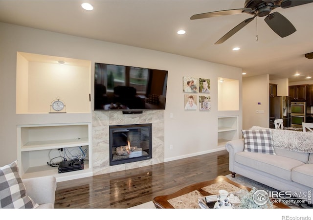 6356 Twilight Ave, Firestone, CO 80504 - living room with built in features, wood finished floors, a premium fireplace, recessed lighting, and a ceiling fan