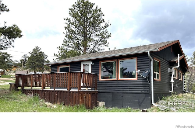 110 Lone Pine Ct, Red Feather Lakes, CO 80545 - view of front facade featuring a wooden deck, roof with shingles, and log veneer siding