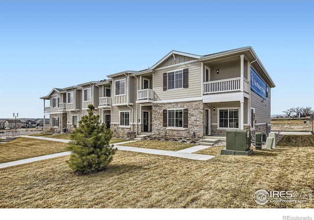 175 Robin Rd, Johnstown, CO 80534 - view of front facade featuring stone siding, board and batten siding, and a balcony