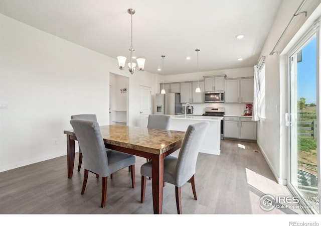 1800 Vantage Pkwy, Berthoud, CO 80513 - dining room with light wood-type flooring, a chandelier, recessed lighting, and baseboards
