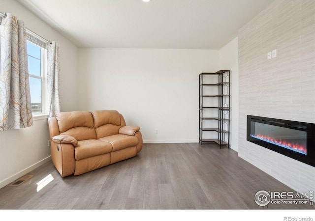1800 Vantage Pkwy, Berthoud, CO 80513 - sitting room with wood finished floors, a tile fireplace, and baseboards