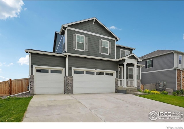 1800 Vantage Pkwy, Berthoud, CO 80513 - view of front facade with an attached garage, stone siding, and driveway