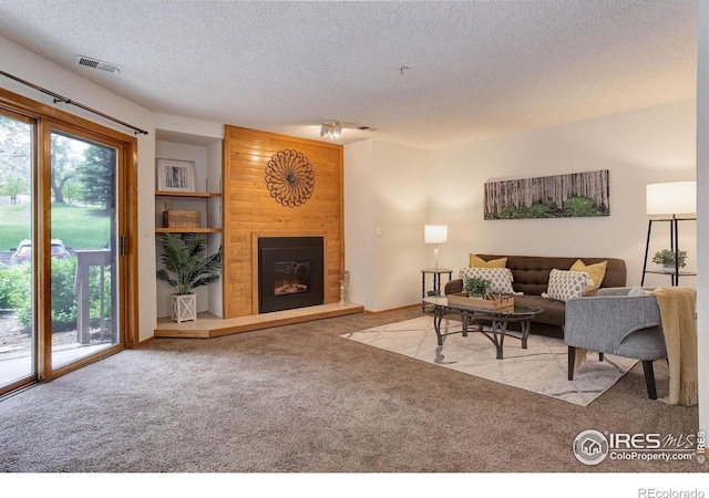 2800 Sundown Ln Unit 109, Boulder, CO 80303 - living area with carpet, a textured ceiling, and a large fireplace