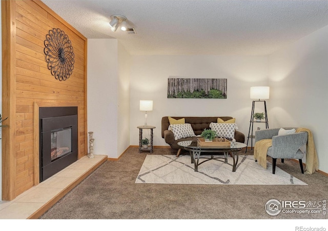 2800 Sundown Ln Unit 109, Boulder, CO 80303 - living area featuring carpet flooring, a fireplace, a textured ceiling, and wood walls