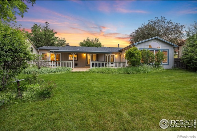 1400 38th Ave, Greeley, CO 80634 - back of house at dusk featuring covered porch