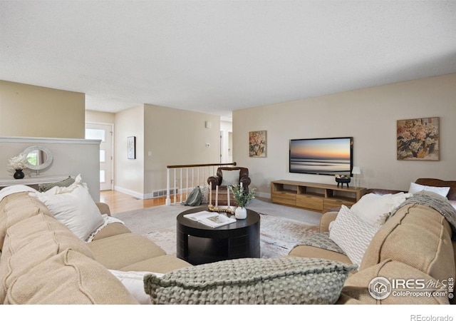 1400 38th Ave, Greeley, CO 80634 - living room featuring baseboards and wood finished floors