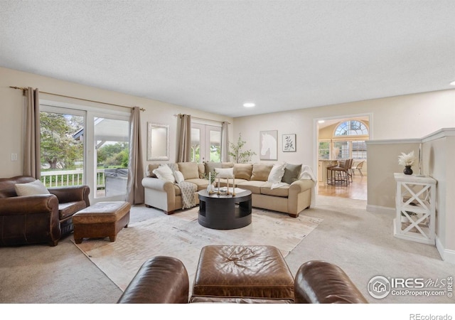 1400 38th Ave, Greeley, CO 80634 - living room with light colored carpet, healthy amount of natural light, recessed lighting, a textured ceiling, and baseboards
