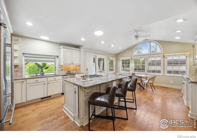1400 38th Ave, Greeley, CO 80634 - kitchen with a sink, appliances with stainless steel finishes, a ceiling fan, light wood-style floors, and vaulted ceiling