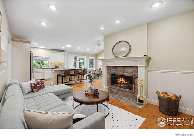 1400 38th Ave, Greeley, CO 80634 - living room with light wood-style flooring, a fireplace, ceiling fan, vaulted ceiling, and recessed lighting