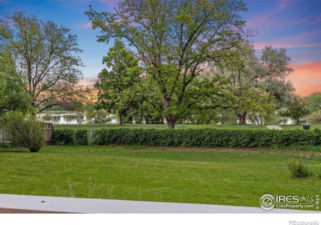 1400 38th Ave, Greeley, CO 80634 - yard at dusk with a water view and a lawn
