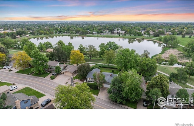 1400 38th Ave, Greeley, CO 80634 - aerial view at dusk of a water view, a residential view, and view of wooded area
