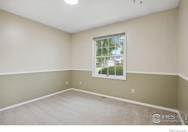 1400 38th Ave, Greeley, CO 80634 - carpeted spare room featuring baseboards and a textured ceiling