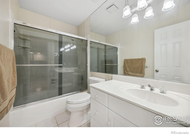 1400 38th Ave, Greeley, CO 80634 - bathroom featuring toilet, bath / shower combo with glass door, vanity, and tile patterned flooring