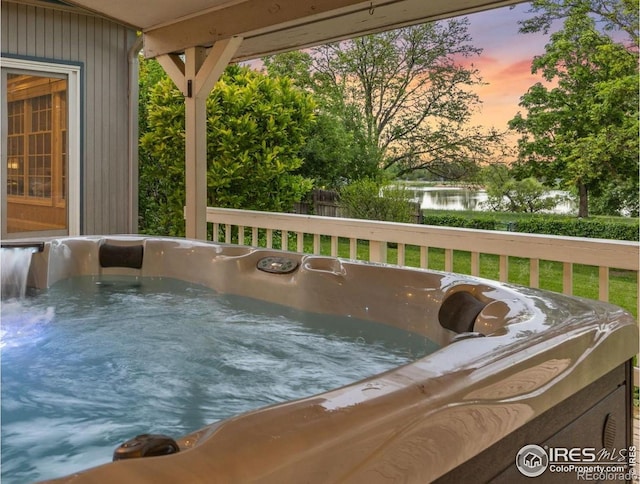 1400 38th Ave, Greeley, CO 80634 - wooden terrace with a hot tub and a water view