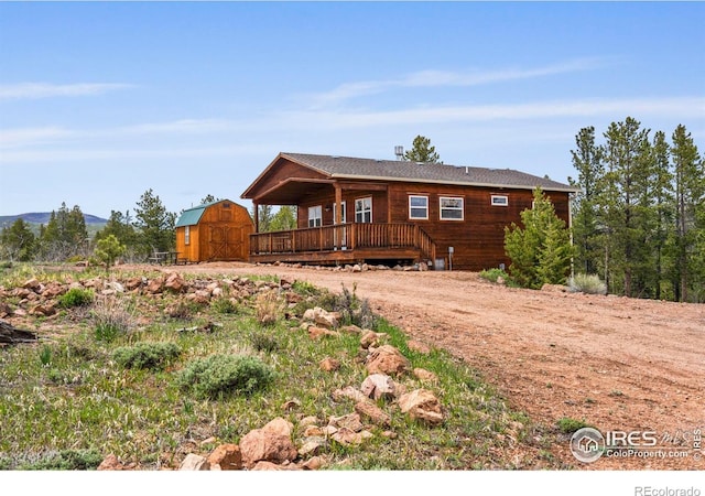 251 Huron Rd, Red Feather Lakes, CO 80545 - rustic home featuring a deck and dirt driveway