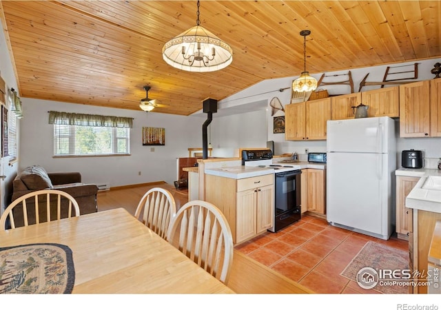 251 Huron Rd, Red Feather Lakes, CO 80545 - kitchen with freestanding refrigerator, range with electric cooktop, vaulted ceiling, a wood stove, and a peninsula