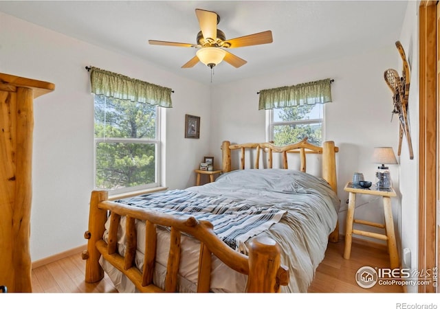 251 Huron Rd, Red Feather Lakes, CO 80545 - bedroom with multiple windows, light wood-style floors, baseboards, and a ceiling fan