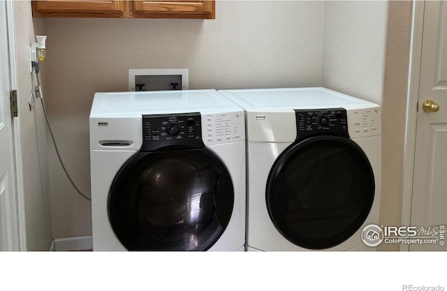 3006 54th Ave, Greeley, CO 80634 - laundry area featuring washer and dryer and cabinet space
