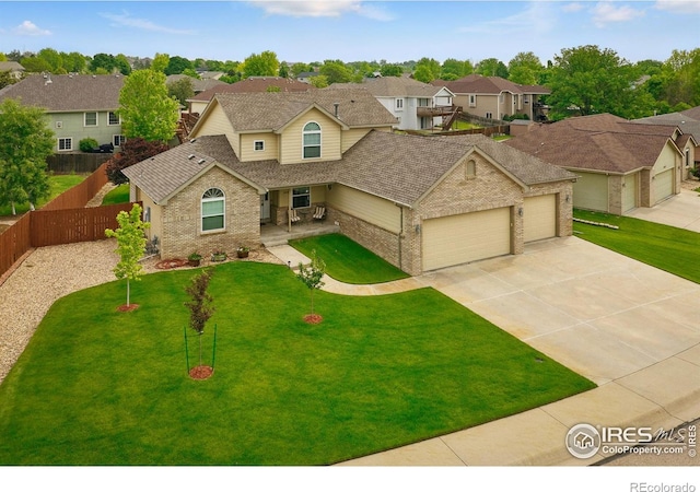 3006 54th Ave, Greeley, CO 80634 - traditional-style house with brick siding, an attached garage, a residential view, driveway, and roof with shingles