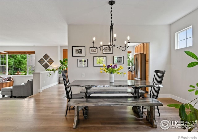 14675 Golden Eagle Run, Broomfield, CO 80023 - dining area with plenty of natural light, a chandelier, and light wood-style floors