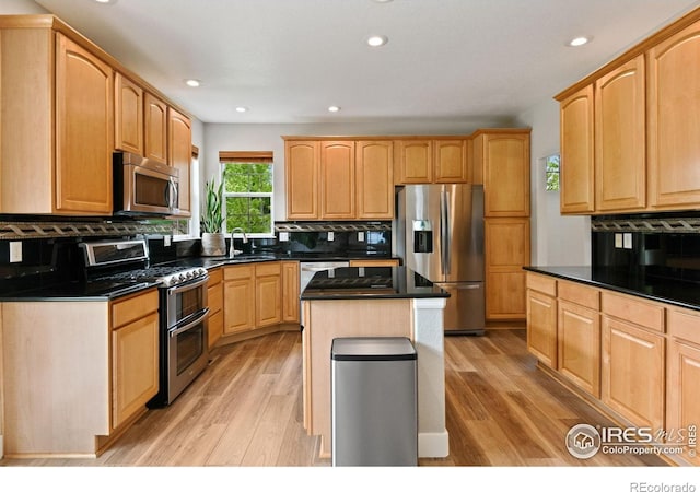 14675 Golden Eagle Run, Broomfield, CO 80023 - kitchen featuring appliances with stainless steel finishes, tasteful backsplash, light wood-style floors, and recessed lighting