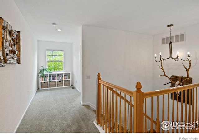 14675 Golden Eagle Run, Broomfield, CO 80023 - hall with an upstairs landing, carpet, a chandelier, and baseboards