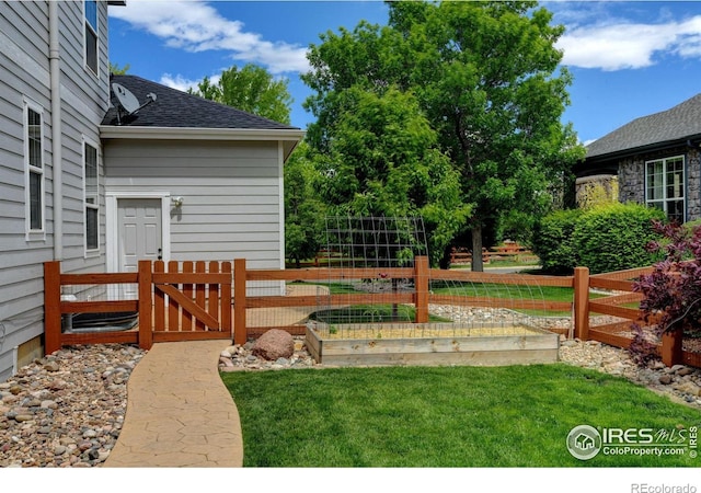 14675 Golden Eagle Run, Broomfield, CO 80023 - view of yard featuring a vegetable garden and a gate