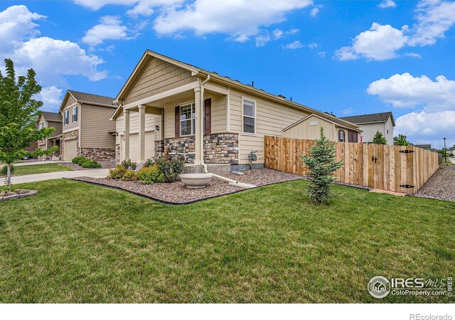 926 Birchdale Ct, Windsor, CO 80550 - view of front facade with a garage, stone siding, and a porch