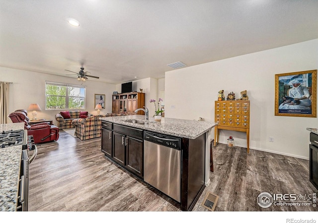 926 Birchdale Ct, Windsor, CO 80550 - kitchen featuring stainless steel appliances, a sink, wood finished floors, open floor plan, and a ceiling fan