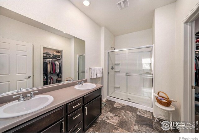 926 Birchdale Ct, Windsor, CO 80550 - bathroom featuring a spacious closet, double vanity, and a shower stall