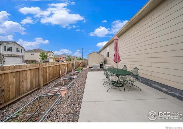 926 Birchdale Ct, Windsor, CO 80550 - fenced backyard with a patio area, a garden, a residential view, and outdoor dining space