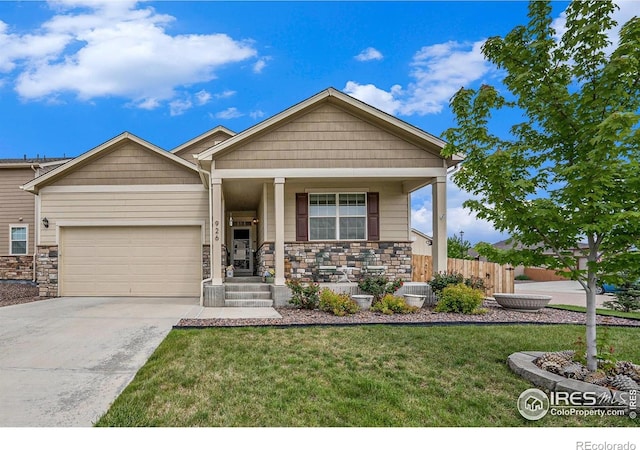 926 Birchdale Ct, Windsor, CO 80550 - view of front of house featuring stone siding, an attached garage, driveway, and a porch